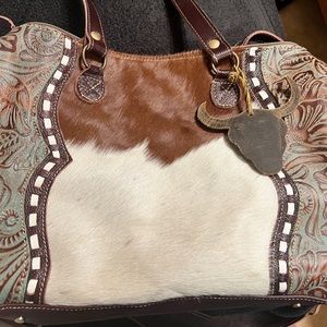Myra cowhide and tooled leather handbag